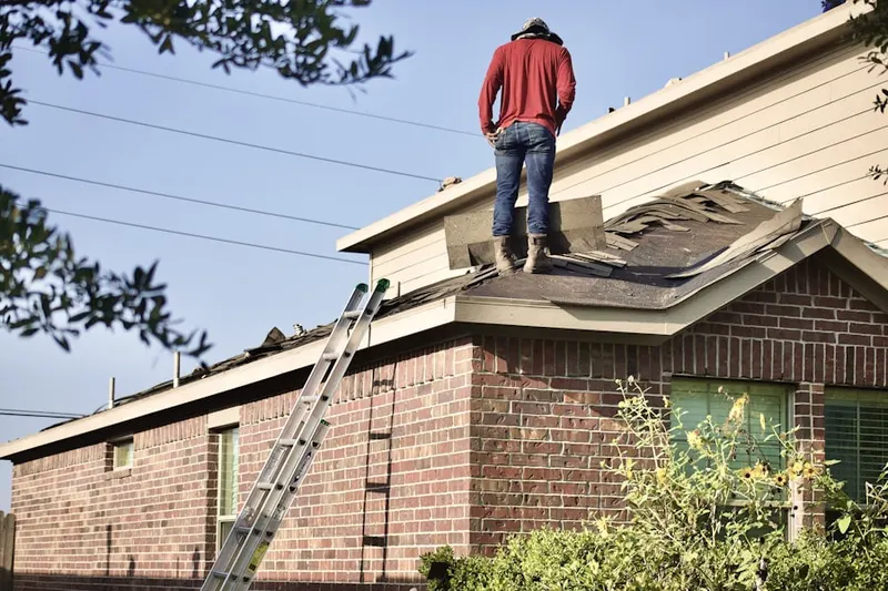 Professional roofer working on a residential roof in Long Ridge